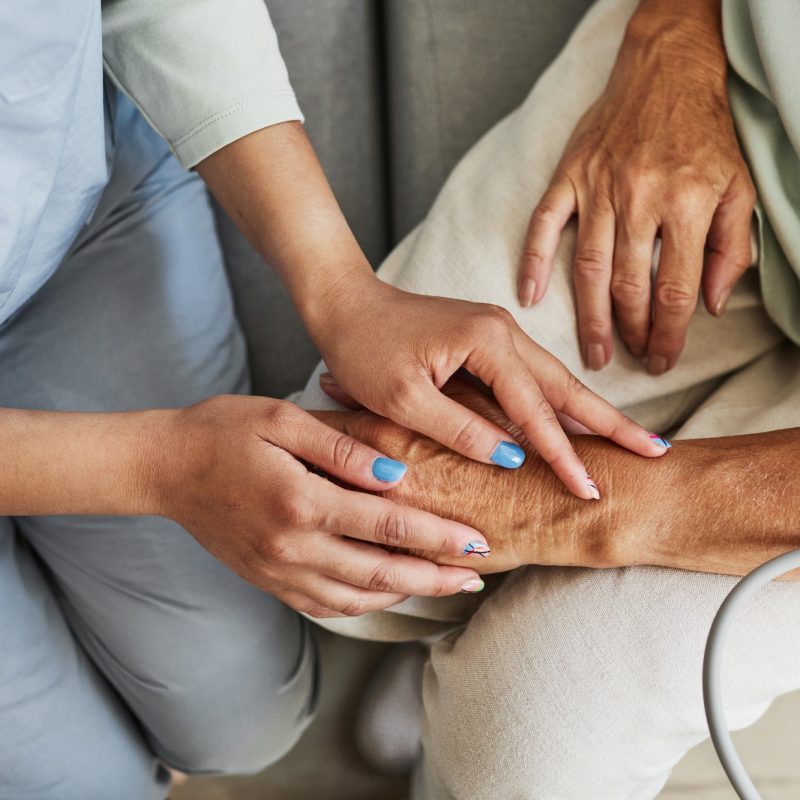 Caring Nurse with Senior Woman in Retirement Home